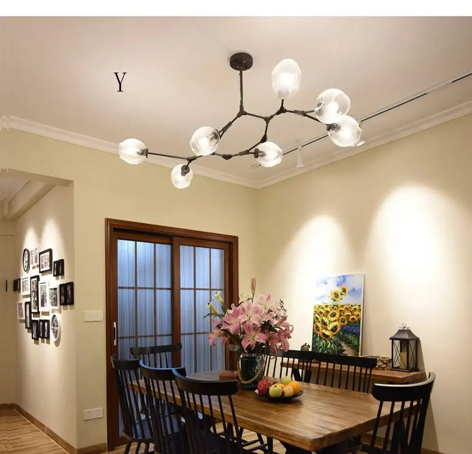 Modern black metal nordic chandelier with frosted glass globe bulbs as a hanging light fixture for living room use