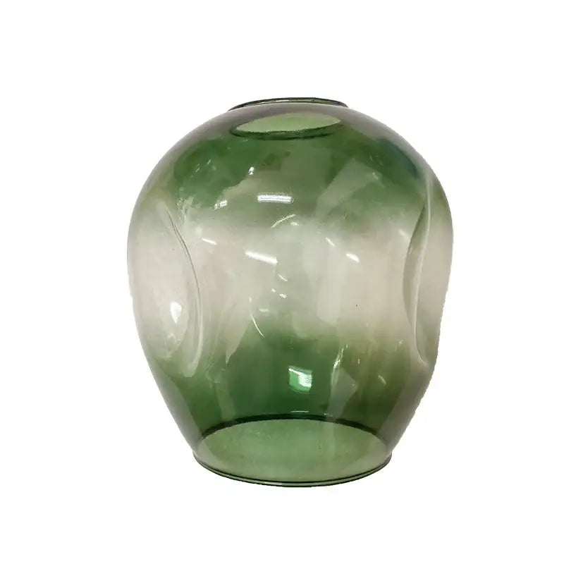 A translucent green glass vase with subtle swirling patterns complements the nordic chandelier hanging light fixture for living room decor