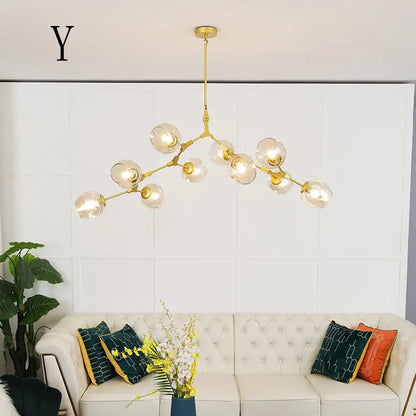 Gold-toned decorbites™ nordic chandelier with clear glass globe bulbs in a branching design for living rooms and dining rooms
