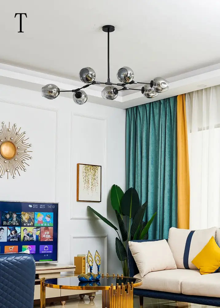 Modern chrome finished nordic chandelier with spherical glass globes on black arm for living rooms and dining areas
