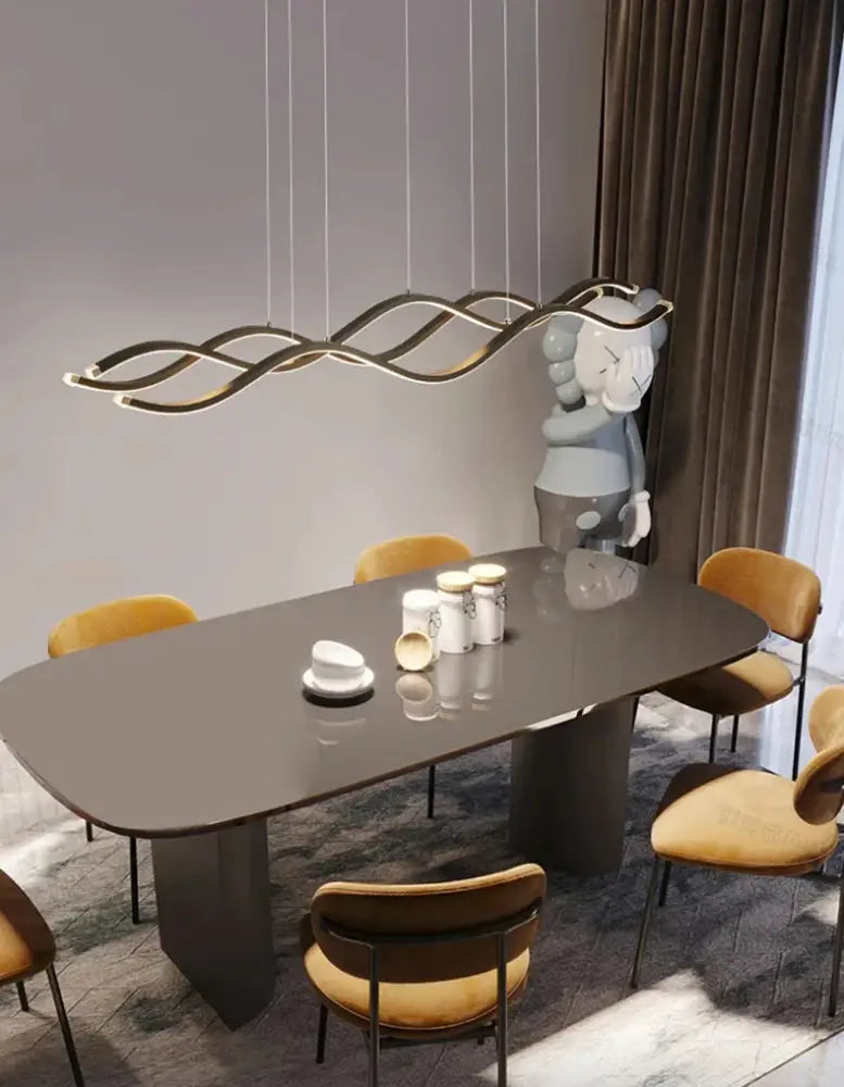 Modern gold-toned wave-shaped pendant light from DecorBites™ nordic chandeliers for dining room lighting above table
