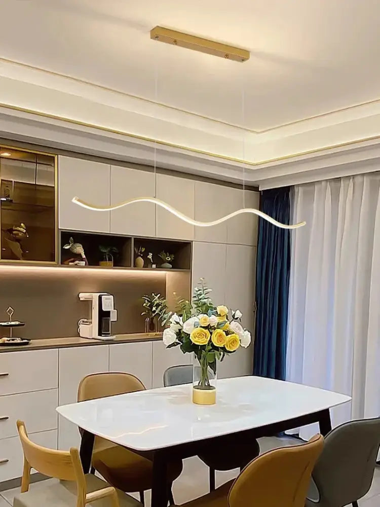 A modern white marble dining table with dark wooden legs paired with decorbites™ nordic chandeliers for dining room lighting