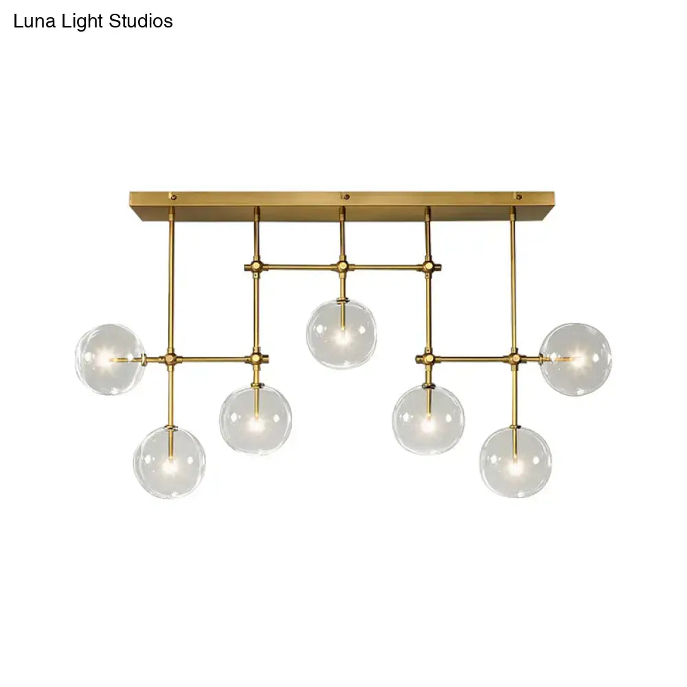 Modern brass-finished ceiling light with six clear glass globes in a geometric pattern for 220v-240v use