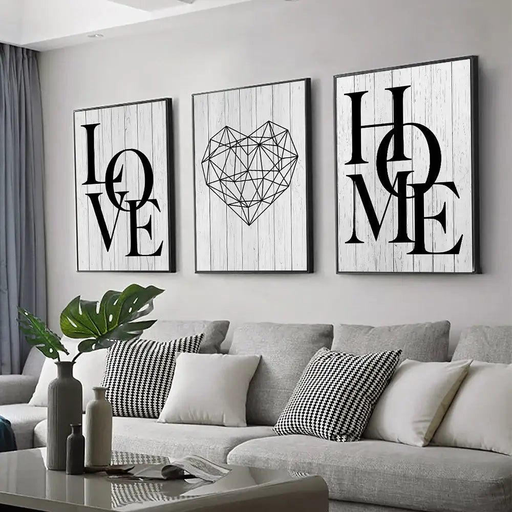 Three framed black-and-white canvas prints by DecorBites featuring nordic diamond heart and word art on wood backgrounds