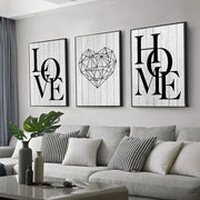 Three framed black-and-white canvas prints by DecorBites featuring nordic diamond heart and word art on wood backgrounds