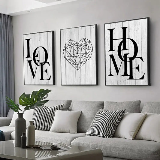Three framed black-and-white canvas prints by DecorBites featuring nordic diamond heart and word art on wood backgrounds