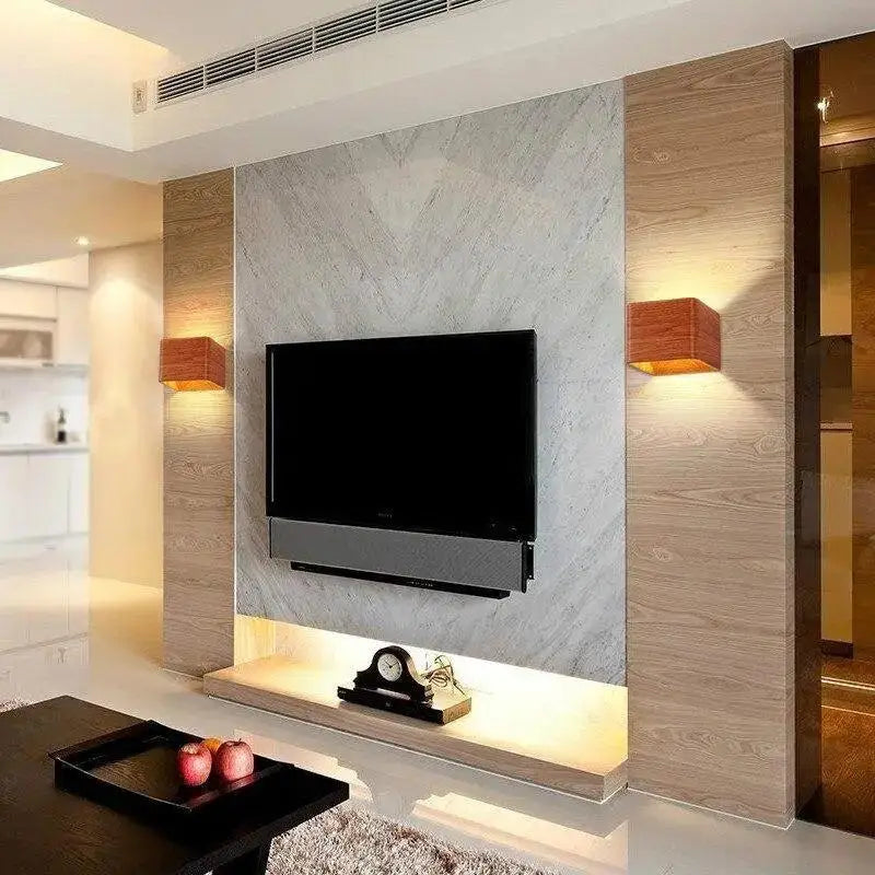 Black flat-screen television mounted on marble and wood-paneled wall with decorbites™ nordic faux wooden wall light