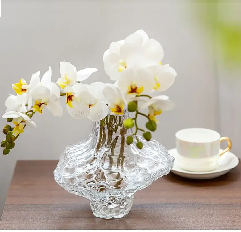 Decorbites™ nordic frosting glass vase is a clear textured frosting glass vase with an organic shape holding white orchids