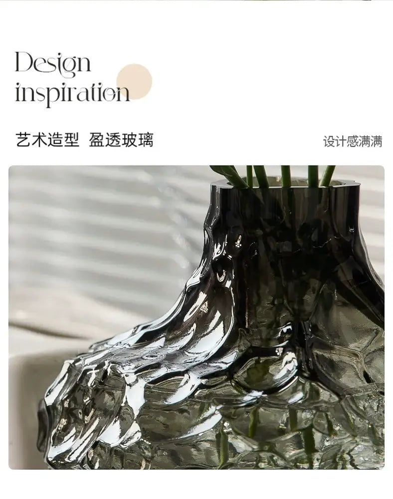 A sleek dark translucent frosting glass vase with an organic sculpted form for modern home decor by DecorBites