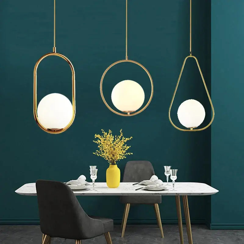 DecorBites™ nordic glass ball pendant light with gold-toned metal frames and frosted glass ball light source above table