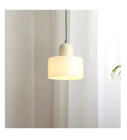 Cream-colored cylindrical nordic glass chandelier pendant light with matte finish and soft diffused glow for bedroom and bar