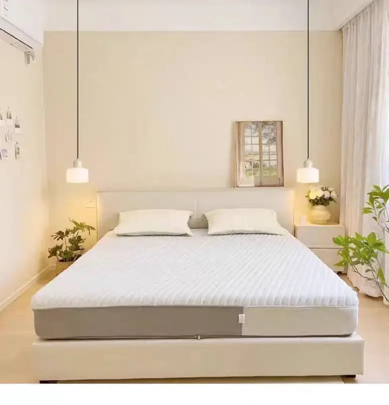 White quilted mattress pad with gray base shown alongside decorbites™ nordic glass chandelier for bedroom and bar use