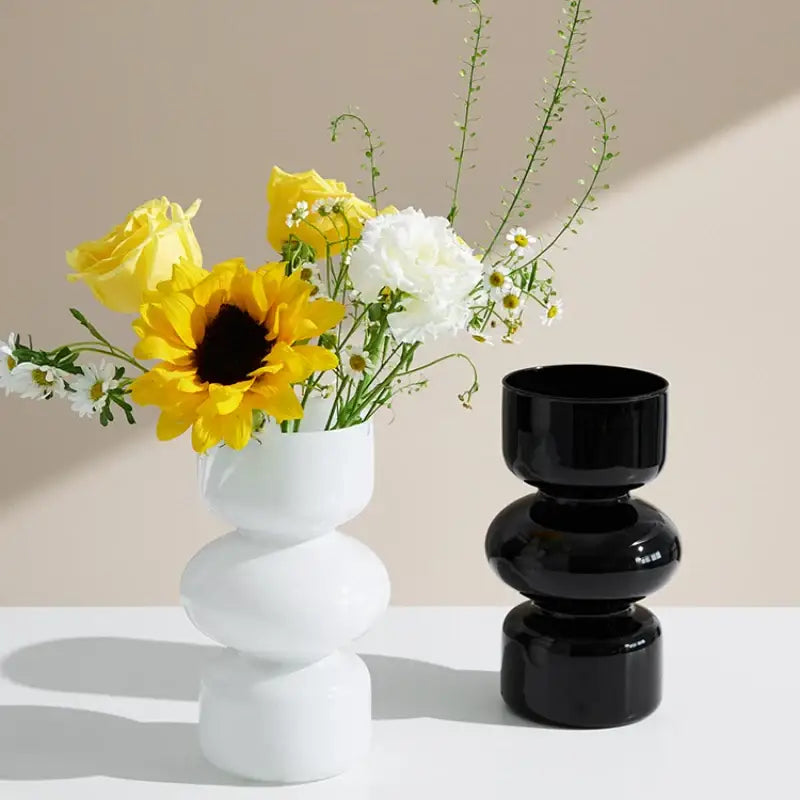 White ceramic DecorBites™ Nordic glass vase home decor with stacked rounded segments holding sunflowers and roses