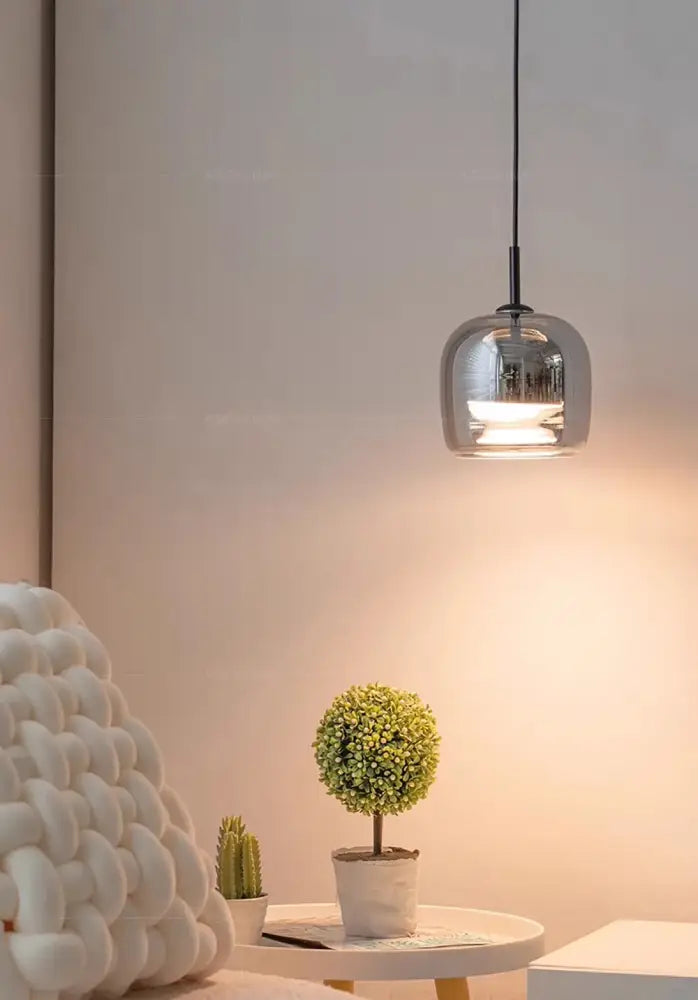 A sleek modern DecorBites™ nordic glass led pendant chandelier with reflective chrome globe and black cord