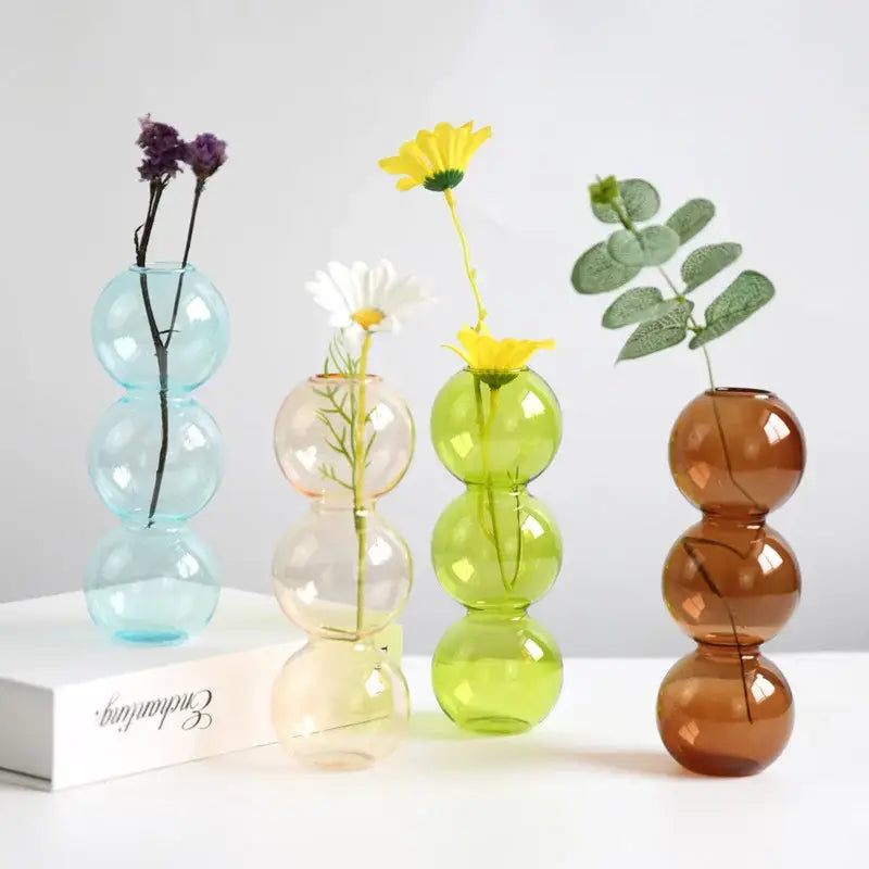 Set of four colorful nordic glass vases with stacked sphere design in light blue peach lime green and amber brown
