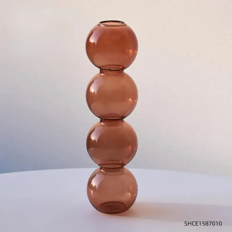 A tall amber-colored nordic glass vase composed of four stacked spherical segments for home decoration gift