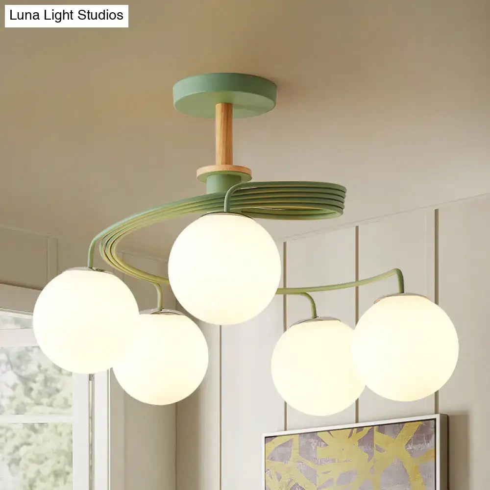 DecorBites™ Nordic iron swirl flush chandelier with five bulbs features grey green wood downrod and frosted orb glass shade