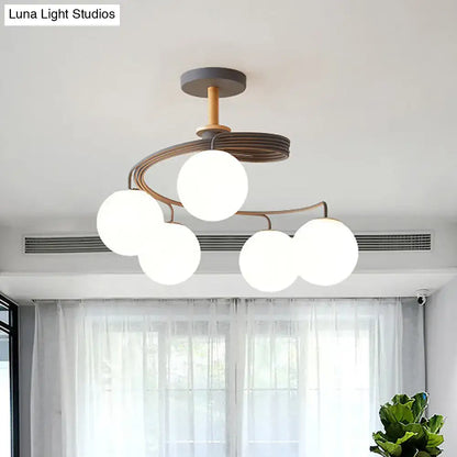Decorbites nordic iron swirl flush chandelier with five orb glass shades on a grey metal frame with wood accents