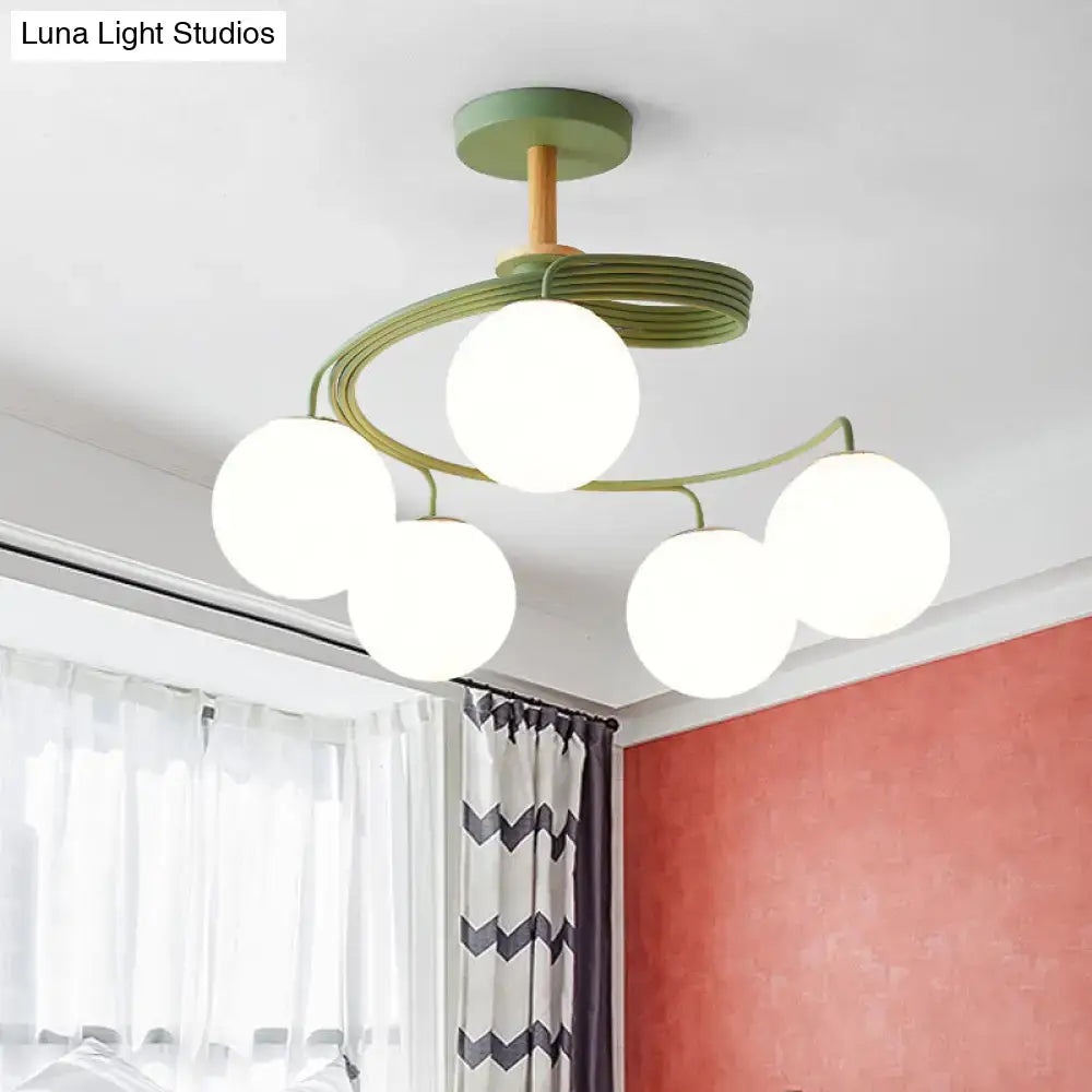 Modern green metal DecorBites Nordic iron swirl flush chandelier with five frosted orb glass shades and wood downrod