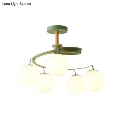 DecorBites™ Nordic iron swirl semi flush ceiling light with five green orb glass shades and wooden downrod accents