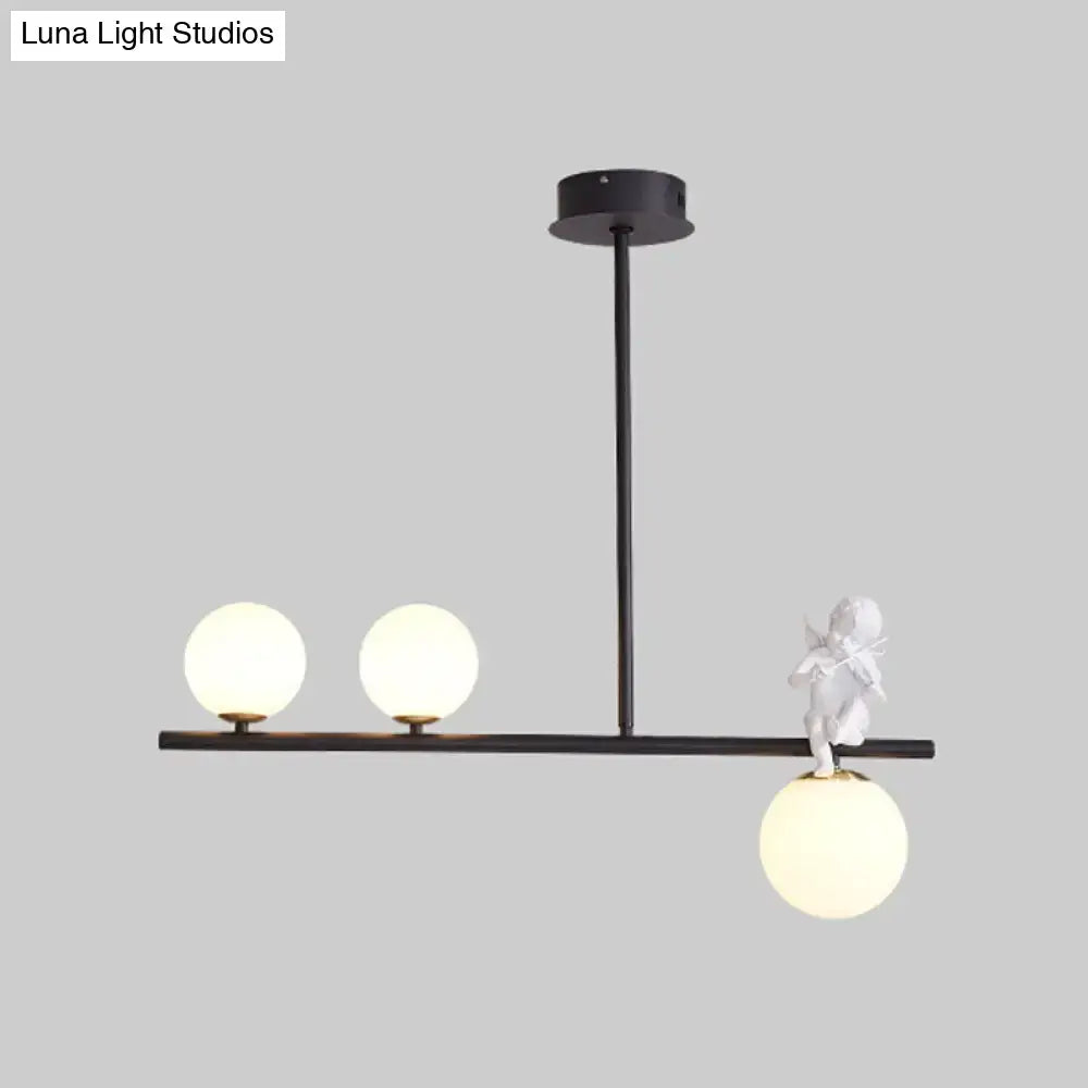 Black DecorBites™ Nordic island pendant light with three frosted opaline glass shades and white angel figurine detail