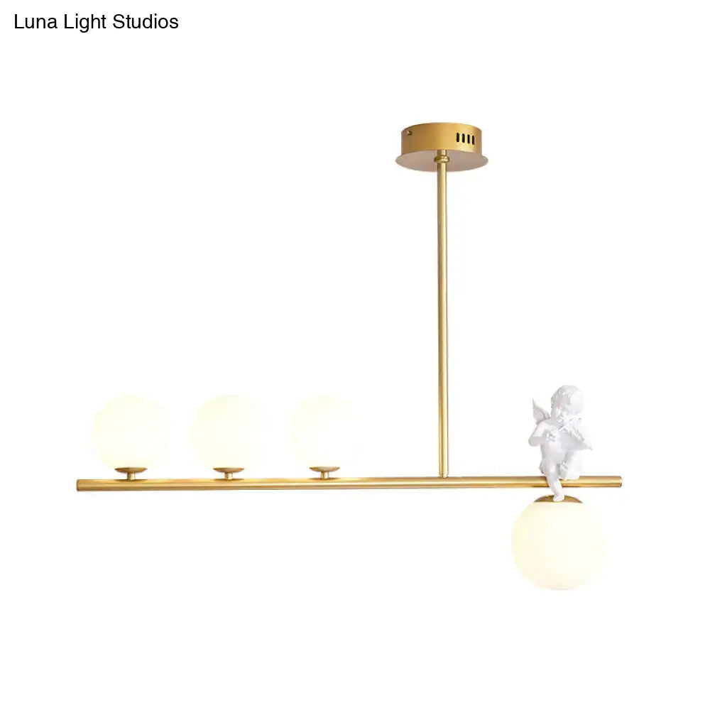 Gold-toned nordic island angel pendant light with three opaline glass shades and decorative white cherub figurine