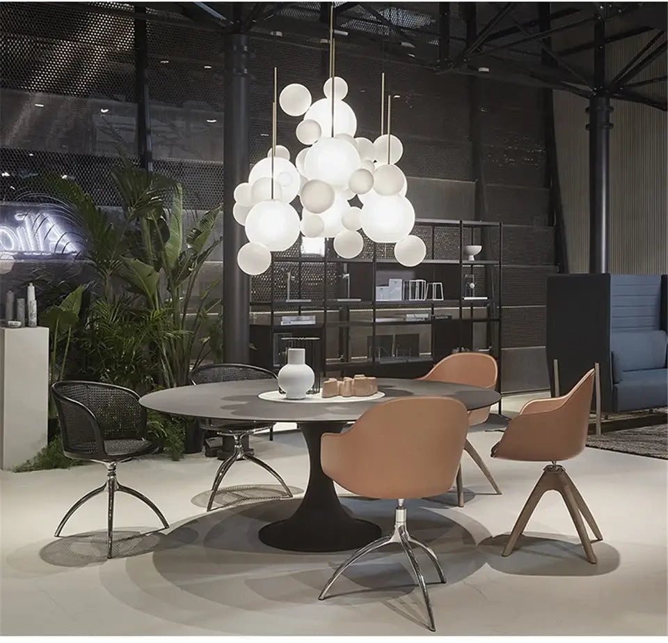 Modern white spherical pendant decor led fixture hanging above a dining table from decorbites nordic led bubble chandelier