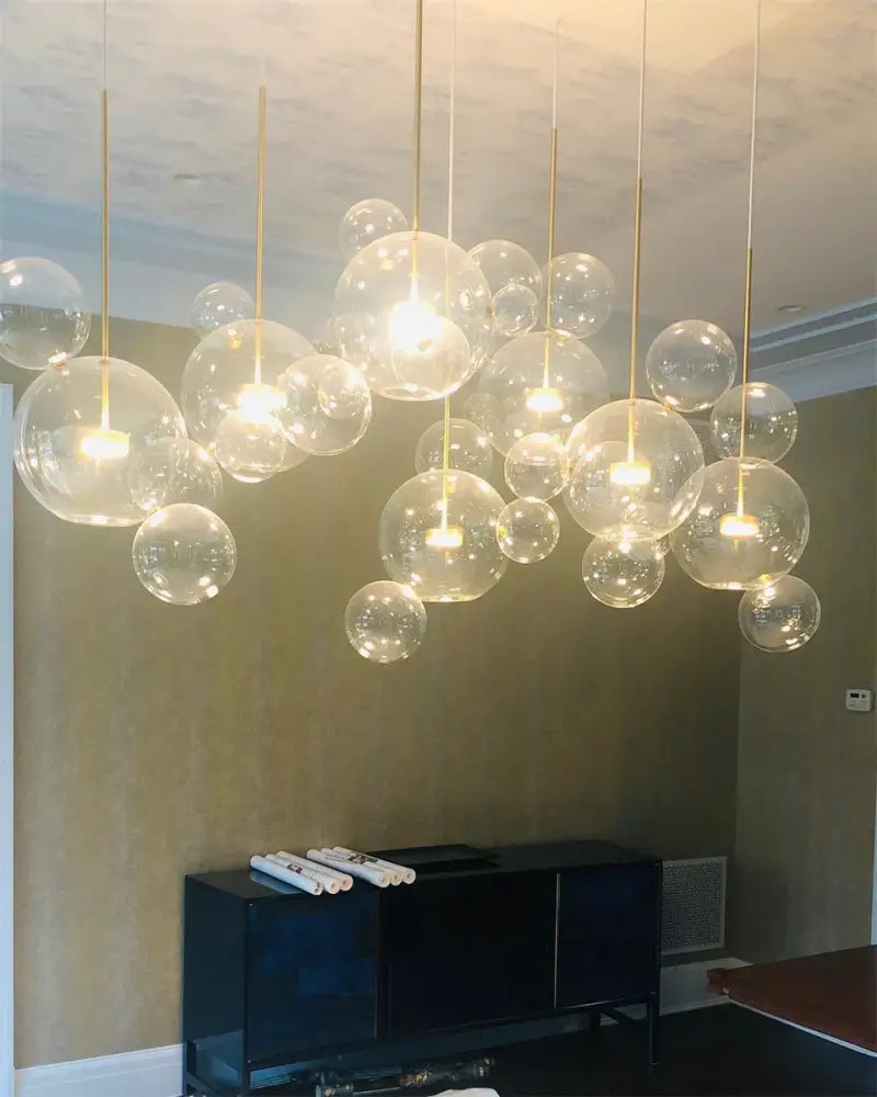 A modern decor led cluster chandelier with transparent glass spheres and gold-toned rods for nordic decor led lighting