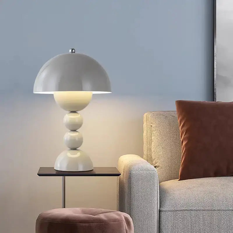 A sleek nordic led table lamp with a matte white dome shade and usb dimmable stacked spherical base for bedside use