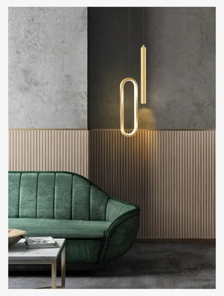 Gold-toned DecorBites™ nordic led pendant light with minimalist geometric design above green velvet sofa