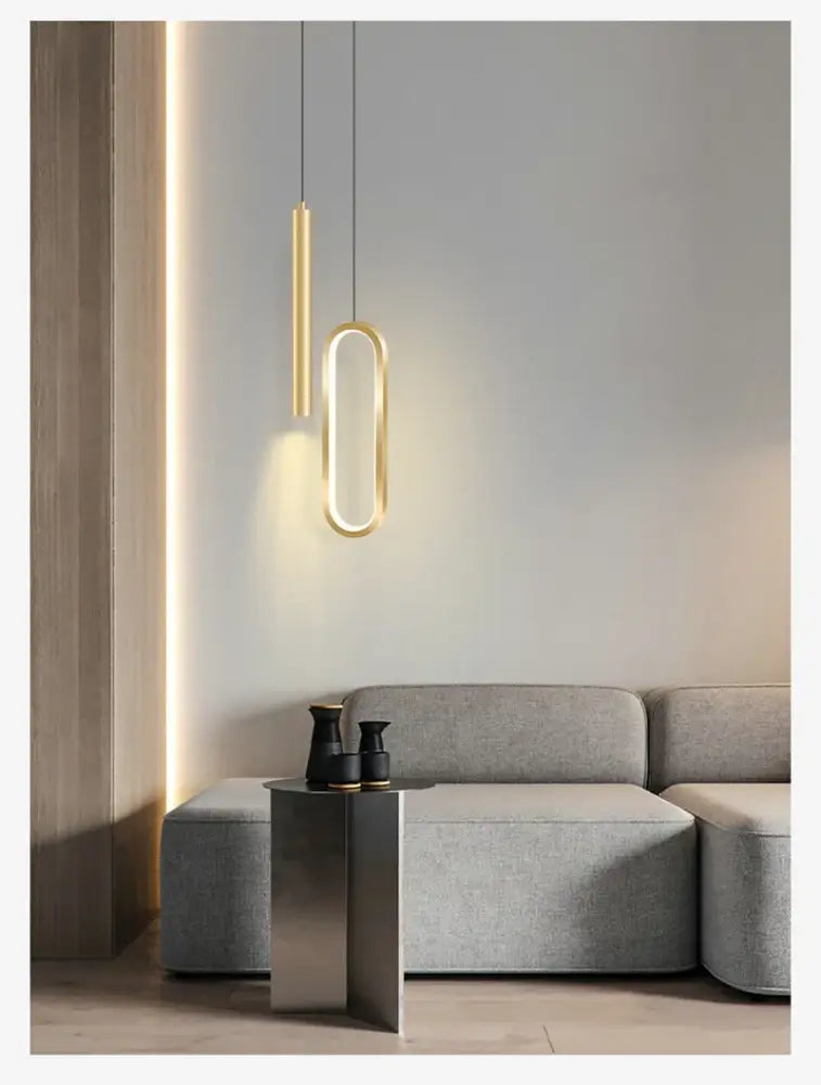 Modern gold-toned DecorBites™ nordic led pendant light with sleek oval and cylindrical design above gray sofa