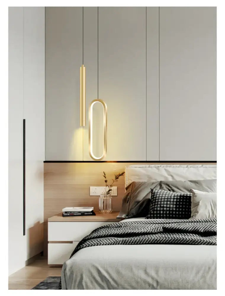 Modern gold-toned decorbites™ nordic led pendant light with sleek oval and cylindrical designs above bed