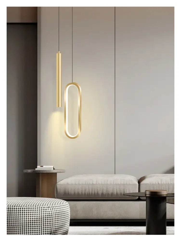 Two modern gold-toned decorbites™ nordic led pendant lights with sleek cylindrical and oval designs for home decoration