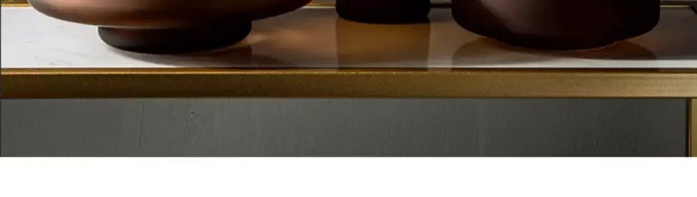 Bronze-toned ceramic bowls with smooth rounded edges and glossy finish complementing frosted glass vase decorbites nordic luxe