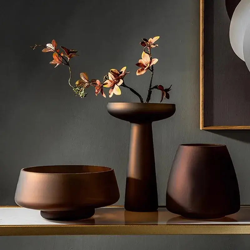 DecorBites™ Nordic Luxe matte bronze ceramic vase with autumn branches complements frosted glass vase decor