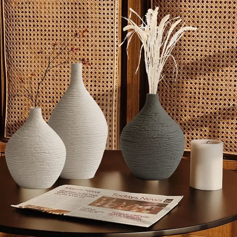 Three textured white and gray ceramic vases with dried floral arrangements nordic luxury ceramic decor vases