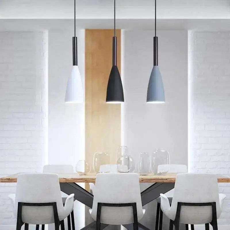 Three DecorBites pendant lights with black stems and white matte black light blue shades for nordic minimalist kitchen island lighting
