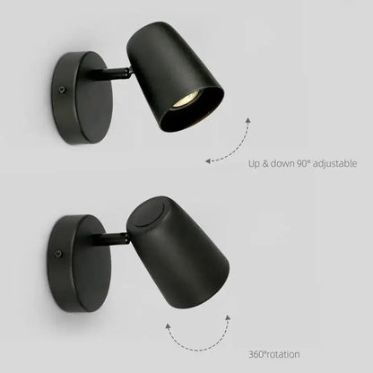 Black matte finished adjustable wall-mounted spotlight with cylindrical head and circular base for modern wall sconces