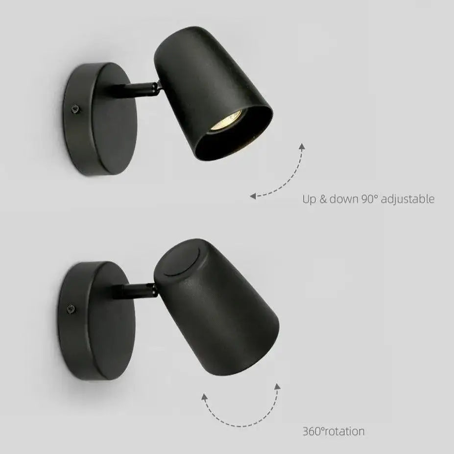 Black matte finished adjustable wall-mounted spotlight with cylindrical head and circular base for modern wall sconces