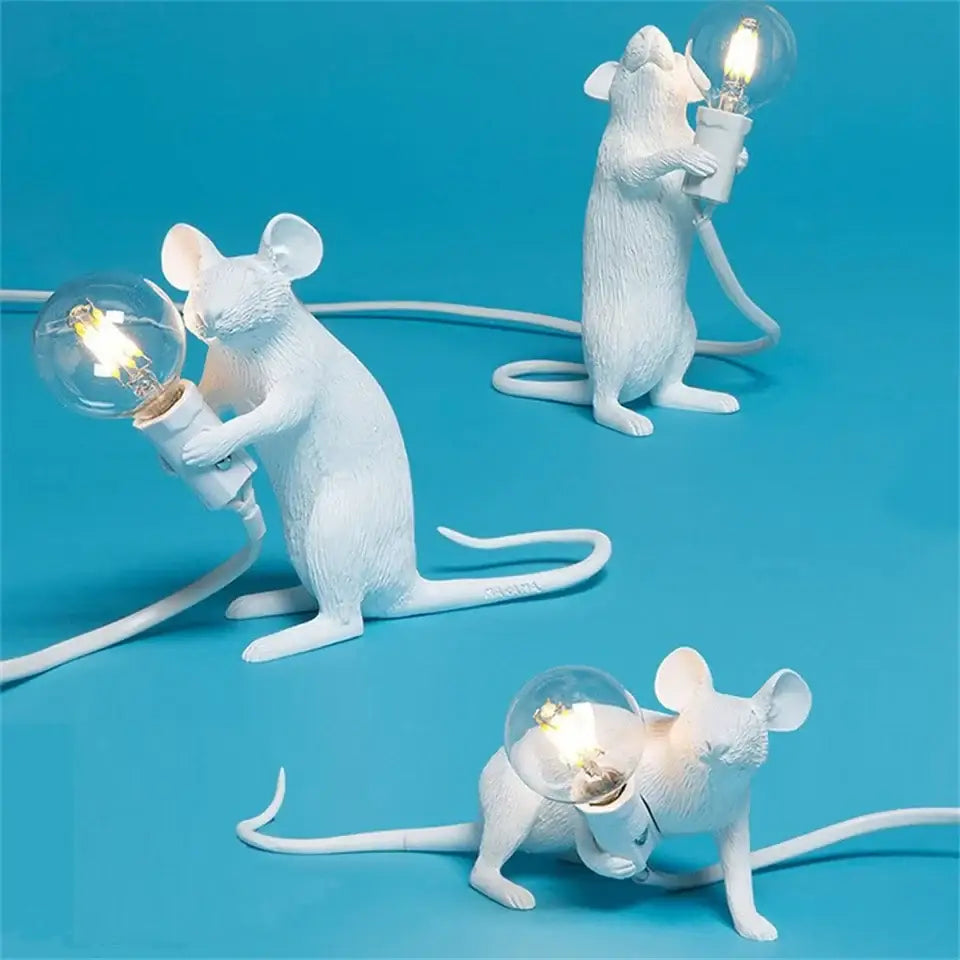 White ceramic nordic mouse led table lamp holding a clear glass bulb for decorative lighting by DecorBites™