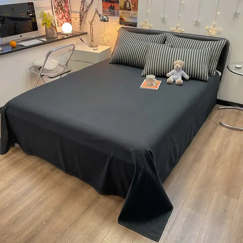 Black satin bed sheet with smooth flowing drape and subtle sheen from decorbites nordic plaid cotton bedding set