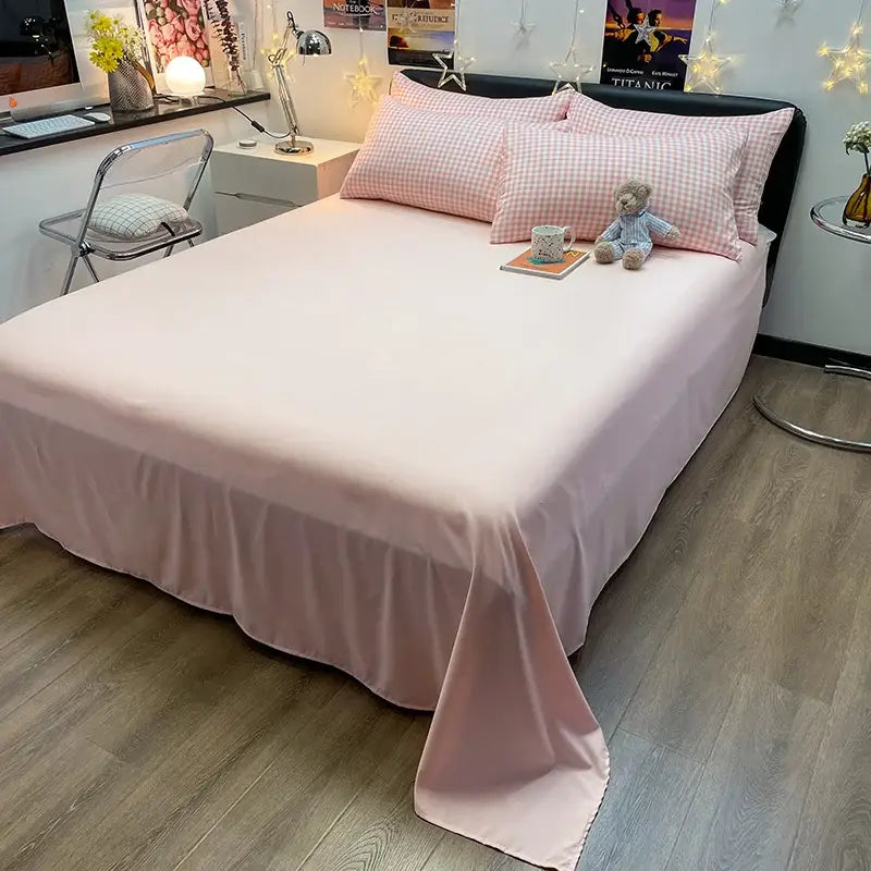 Pink satin bed sheet with ruffled hem as part of decorbites nordic plaid cotton bedding set queen king