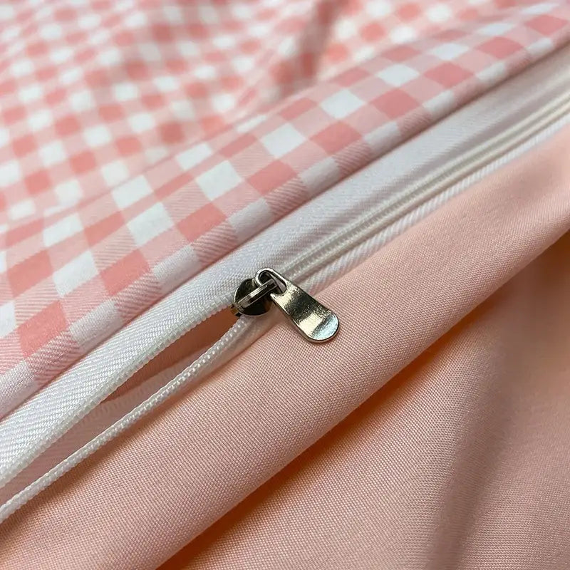 Silver-toned zipper pull on nordic plaid cotton bedding set with soft pink and white gingham pattern for queen king beds