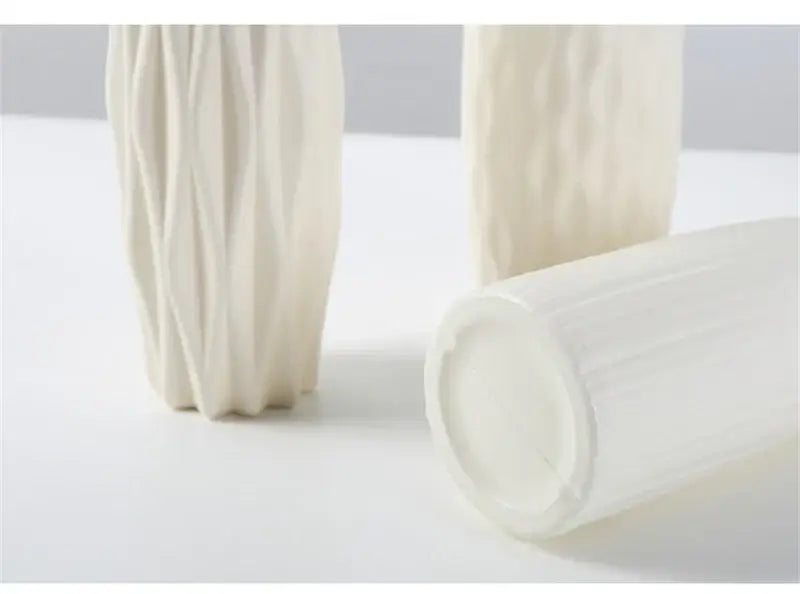 Cream-colored nordic plastic vase with vertical ribbed texture for modern home decor by DecorBites™