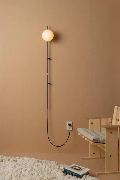 Decorbites™ nordic plug in wall lamp sconce with sleek black metal frame and warm glowing spherical bulb lamp sconce