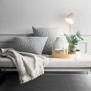 Gray quilted throw pillows with hexagonal texture on sofa complement decorbites™ nordic plug in wall sconce wall light