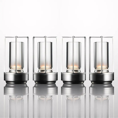 Four sleek nordic rechargeable table lamps with metallic frames and clear glass housing warm led lights by decorbites