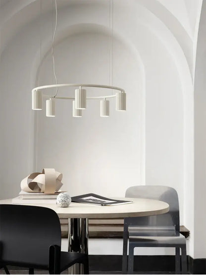 Minimalist white ceramic decorbites™ nordic rotatable donna circle chandelier with cylindrical fixtures above dining table