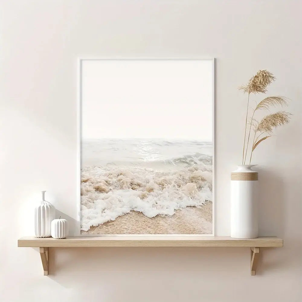 A minimalist nordic seascape canvas wall art featuring soft beige and white beach wave tones in a sleek white frame
