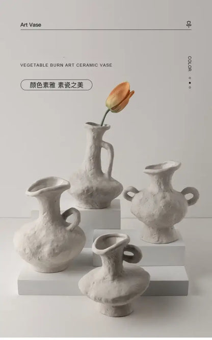 A collection of four off-white nordic style ceramic flower pots with textured handcrafted surfaces and unique handles